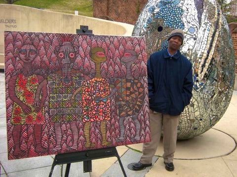 Ephrem Kouakou with one of African paintings for sale on True African Art .com