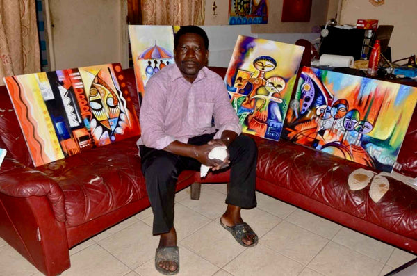 Olumide with the African paintings he made for sale on our website