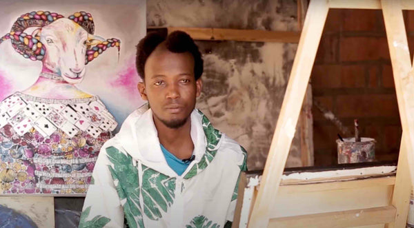 African Artist Seleman Kubwimana from Rwanda with one his paintings