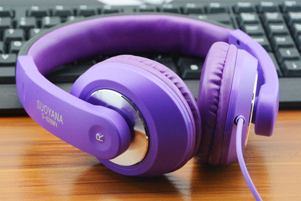 purple gaming headset on gaming setup