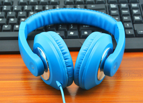 blue headset on gaming setup