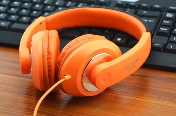 orange headset on gaming setup