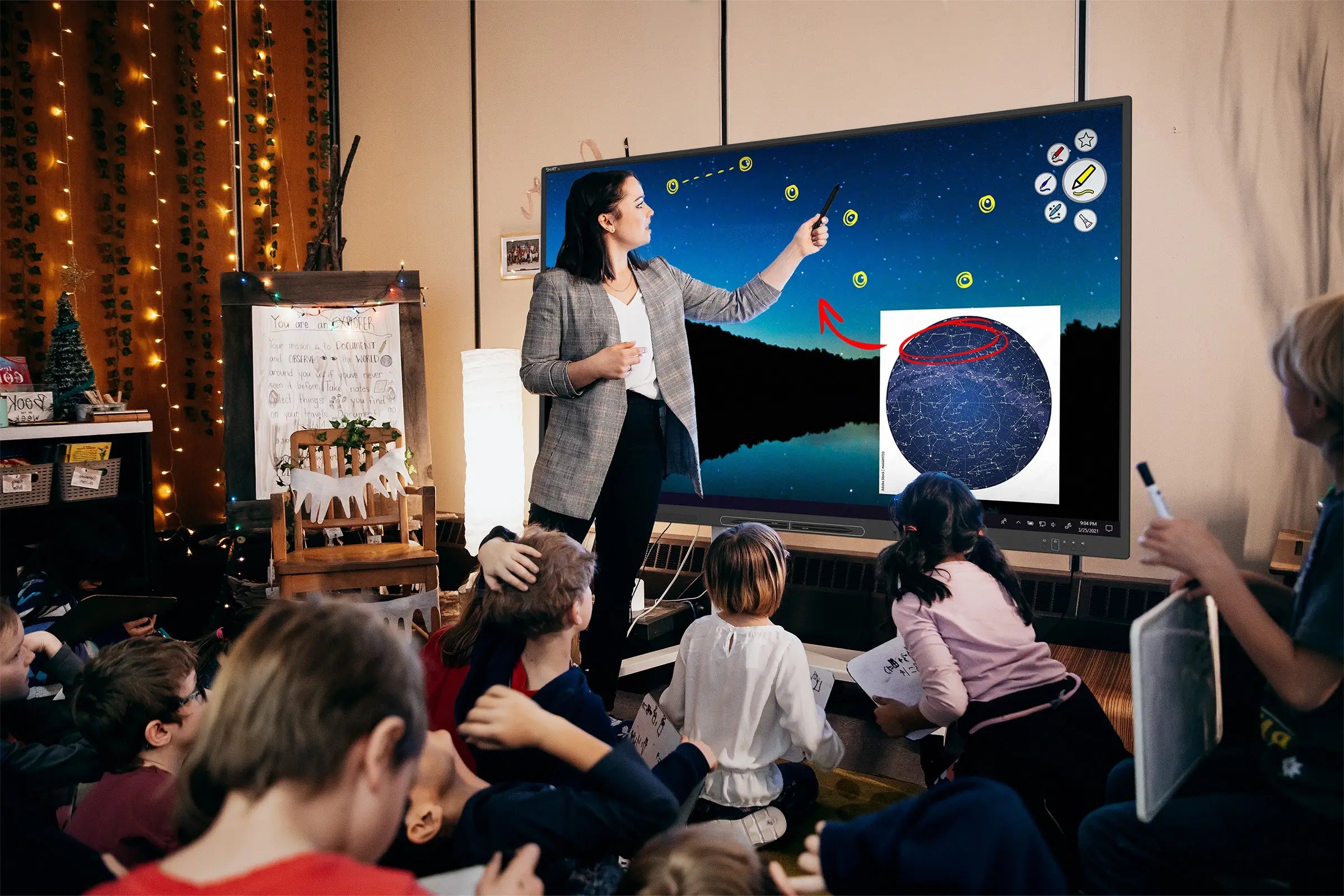 Two young boys in a classroom playing a science game on a SMART Board 