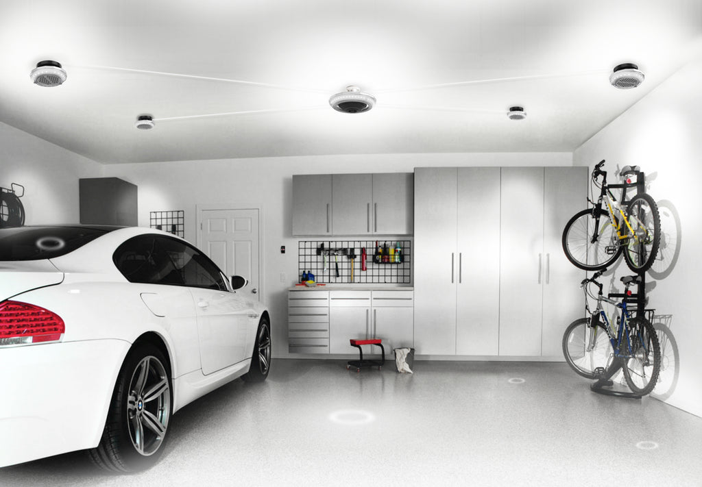 Image of a clean white garage with white car all illuminated by a MPI full garage lighting solution