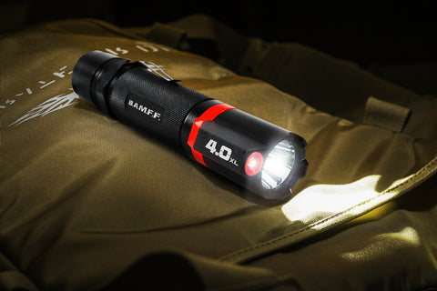 BAMFF Tactical Flashlight sitting on a bag