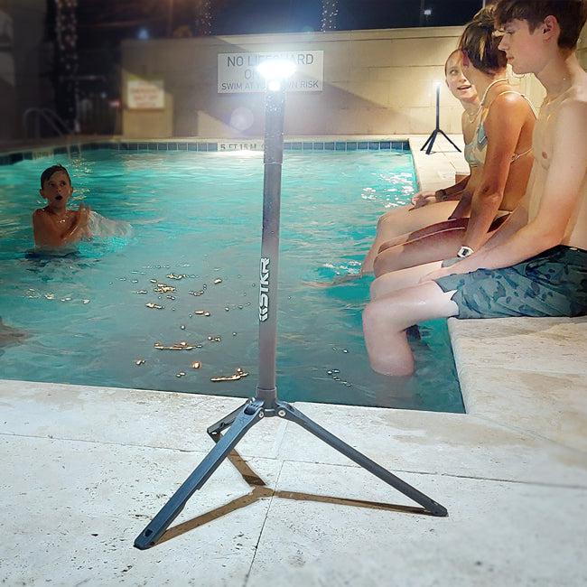 kids playing in a pool at night illuminated by two FLi-PRO telescoping lanterns