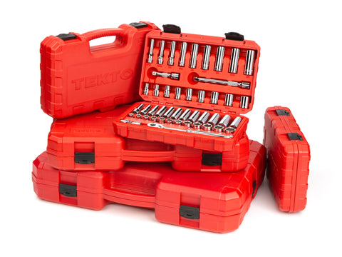 portable tool kits in a pile. top one is open showing a socket set