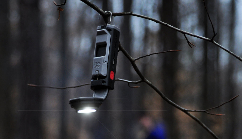 STKR's FLEXIT Pocket Light hanging from a tree limb by it's built-in hanging hook