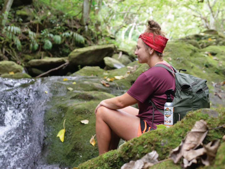 woman sitting next to waterfall in hawaii with ranger ready picaridin (icaridin) mosquito and tick repellent