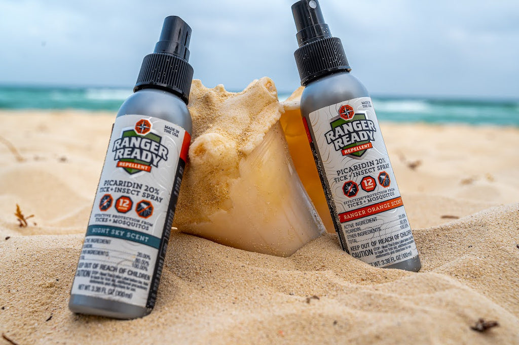 ranger ready insect repellent on the beach in the sand leaning on a seashell