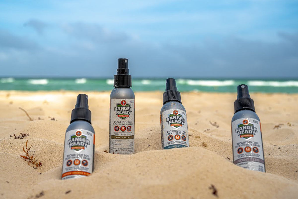 ranger ready Picaridin 20% insect repellents in the sand at the beach during the summer with blue skies and waves in the ocean