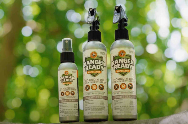 Ranger Ready Picaridin 20% Insect Repellents sitting on a tree branch in the woods