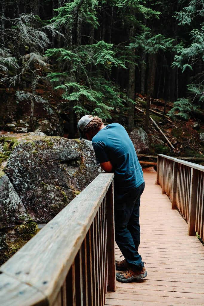 person in the woods standing on a wood bridge in washington