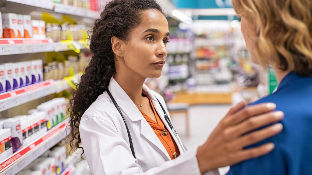 woman pharmacist helps customer in pharmacy