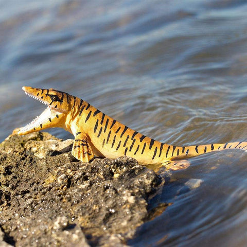 Tylosaurus Safari Ltd toy figurine on a shore.