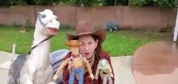 Connie's Mom holds a Buzz Light Year and Woody Doll 