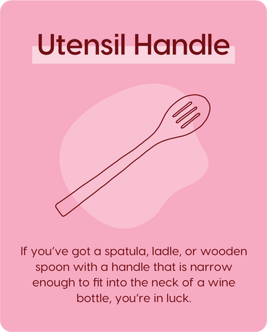 Pink background graphic with line drawing of a slotted wooden spoon, with text overlaid: Utensil Handle, If you've got a spatula, ladle, or a wooden spoon with a handle that is narrow enough to fit into the next of a wine bottle, you're in luck