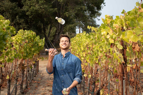 CRO Zach Feinberg juggles IGT Mini Bottles in a Vineyard