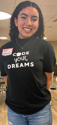 Girl wearing black CODE YOUR DREAMS t-shirt and smiling