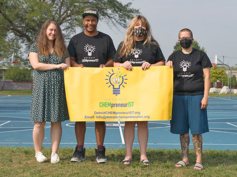 Four people holding Detroit CHEMpreneurIST sign and three people wearing CLOZTALK t-shirts