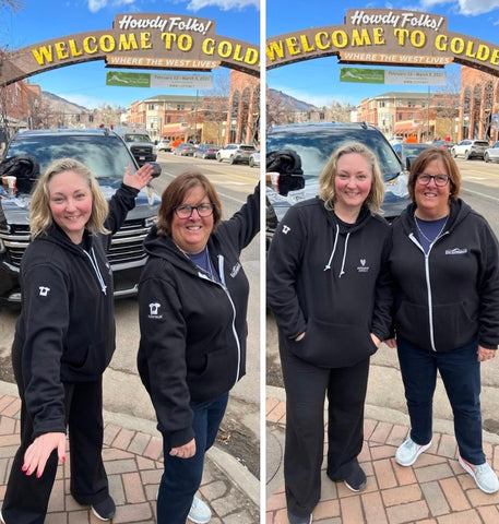 Woman wearing Imerman Angels CLOZTALK hoodie and woman wearing Epic Experience CLOZTALK hoodie outside on sidewalk.