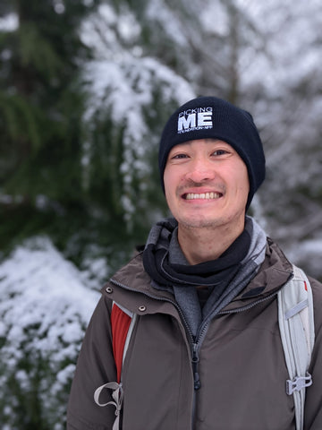 Man wearing Picking Me Foundation winter hat outdoors in winter