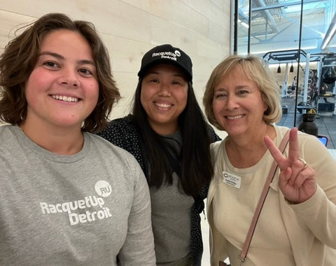 Three women posing for a selfie; two women are wearing Racquet Up Detroit gear