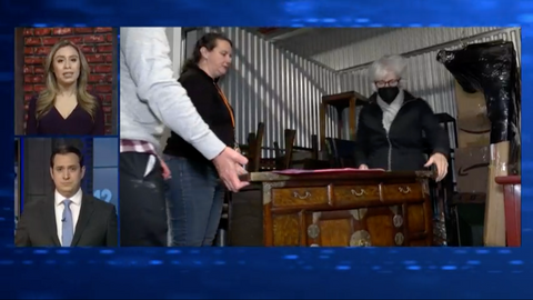 TV story showing two women moving a wooden desk for Ruth's Refuge 