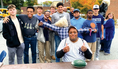 About 15 young kids posing for the photo