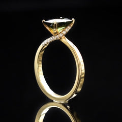 Green tourmaline solitaire engagement ring with twisted shank