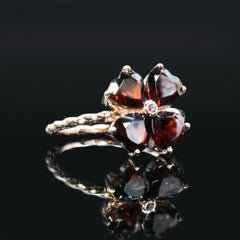 Garnet cremation ring with ashes, clover design