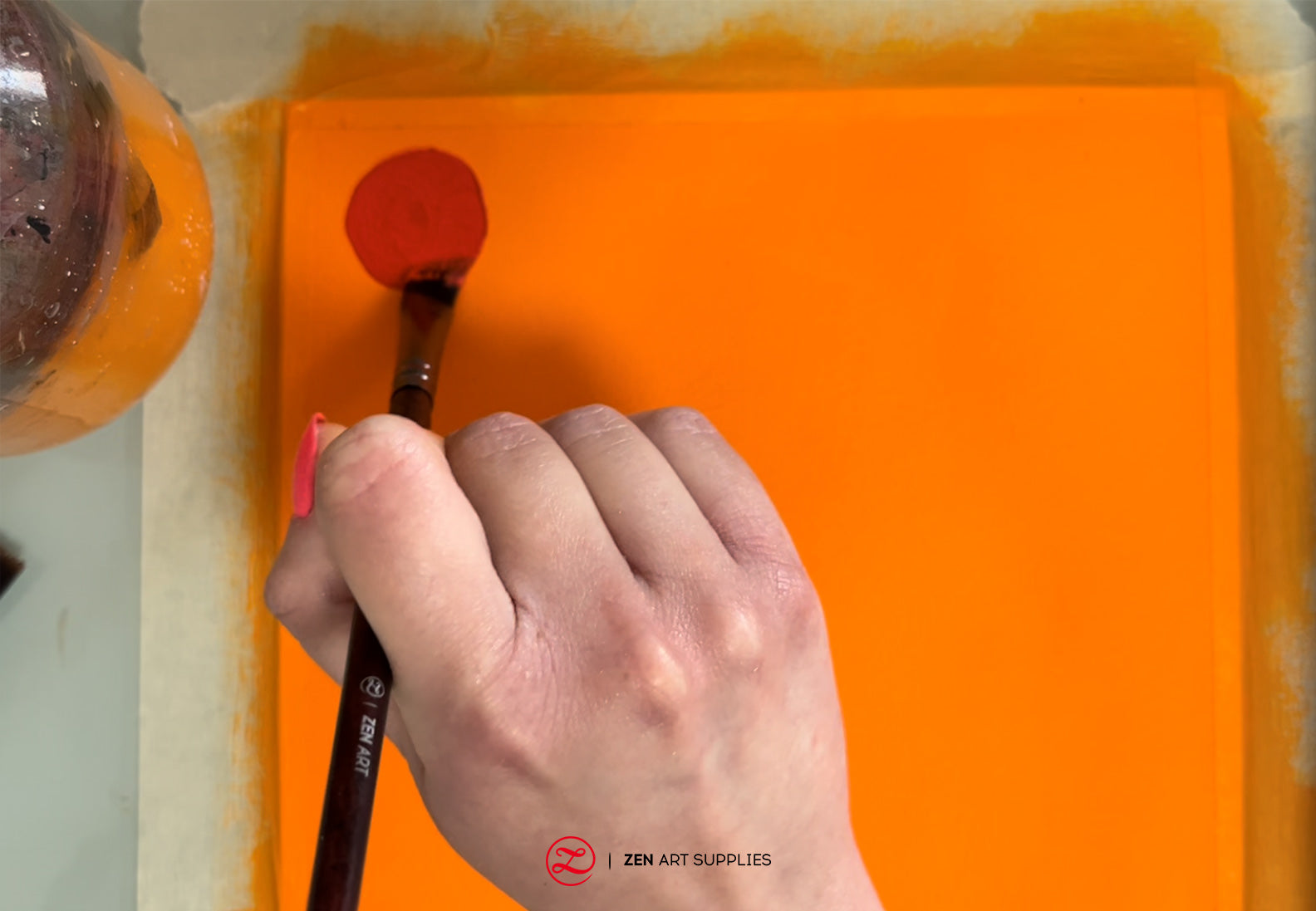 Painting red circles using a #8 Angled flat brush.