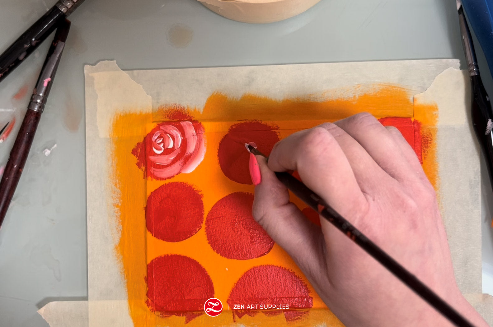 Painting semi-circles with white gouache to suggest flower petals overlapping each other.