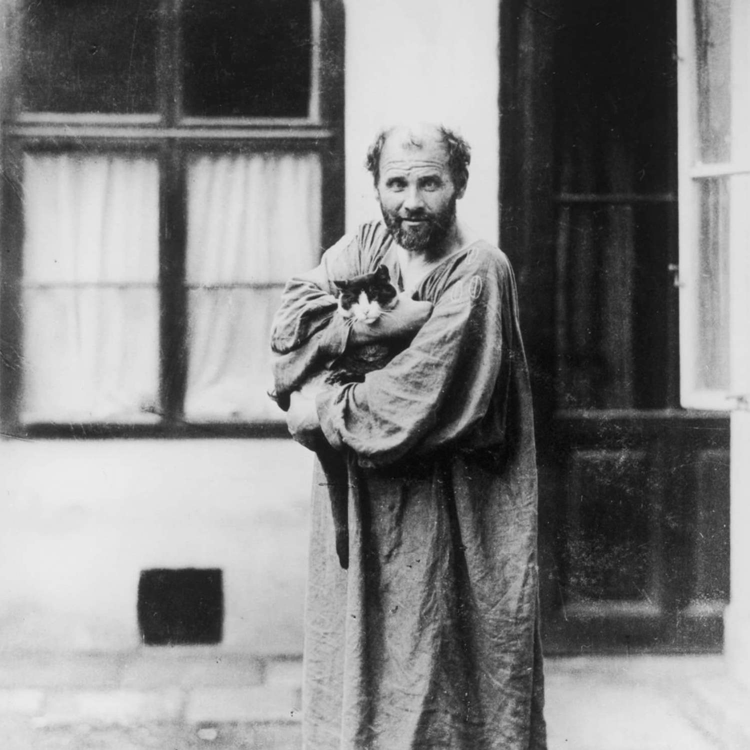 A famous picture of Gustav Klimt holding one of his cats