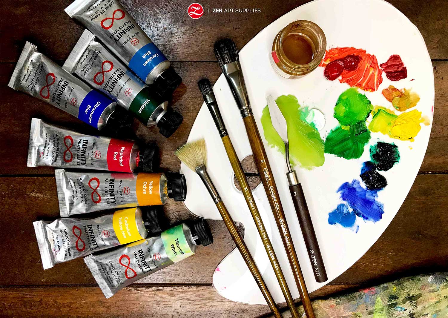 Used Paint Brushes On A Colorful Painter Palette Stock Photo
