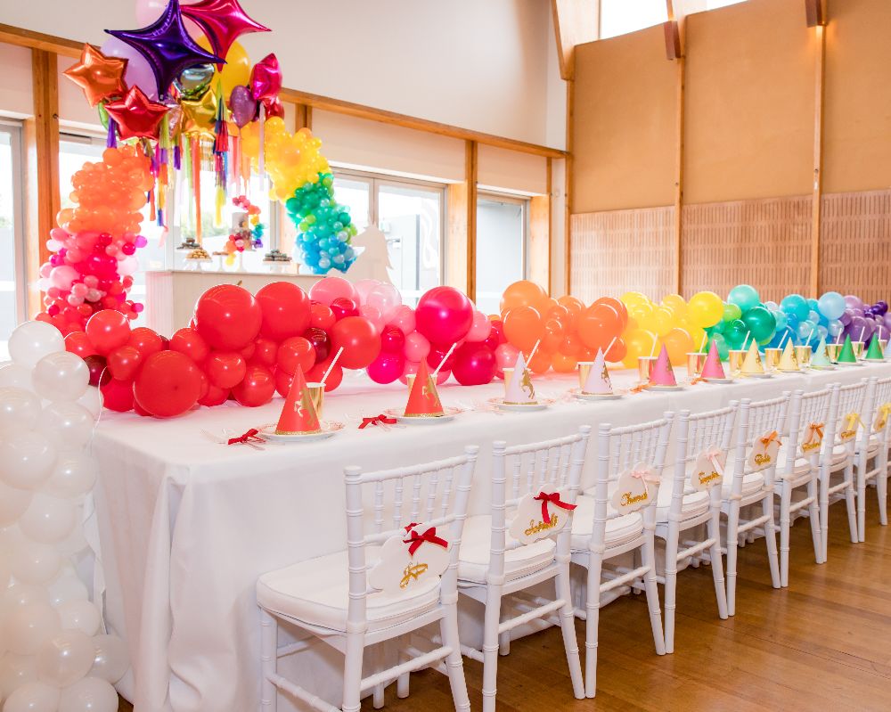 Unicorn Party styled kids table with balloon party decoration
