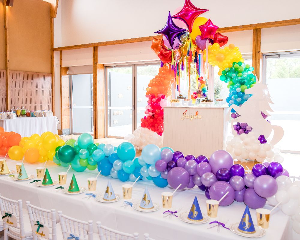 Kids table with rainbow balloon runner with life size unicorn 