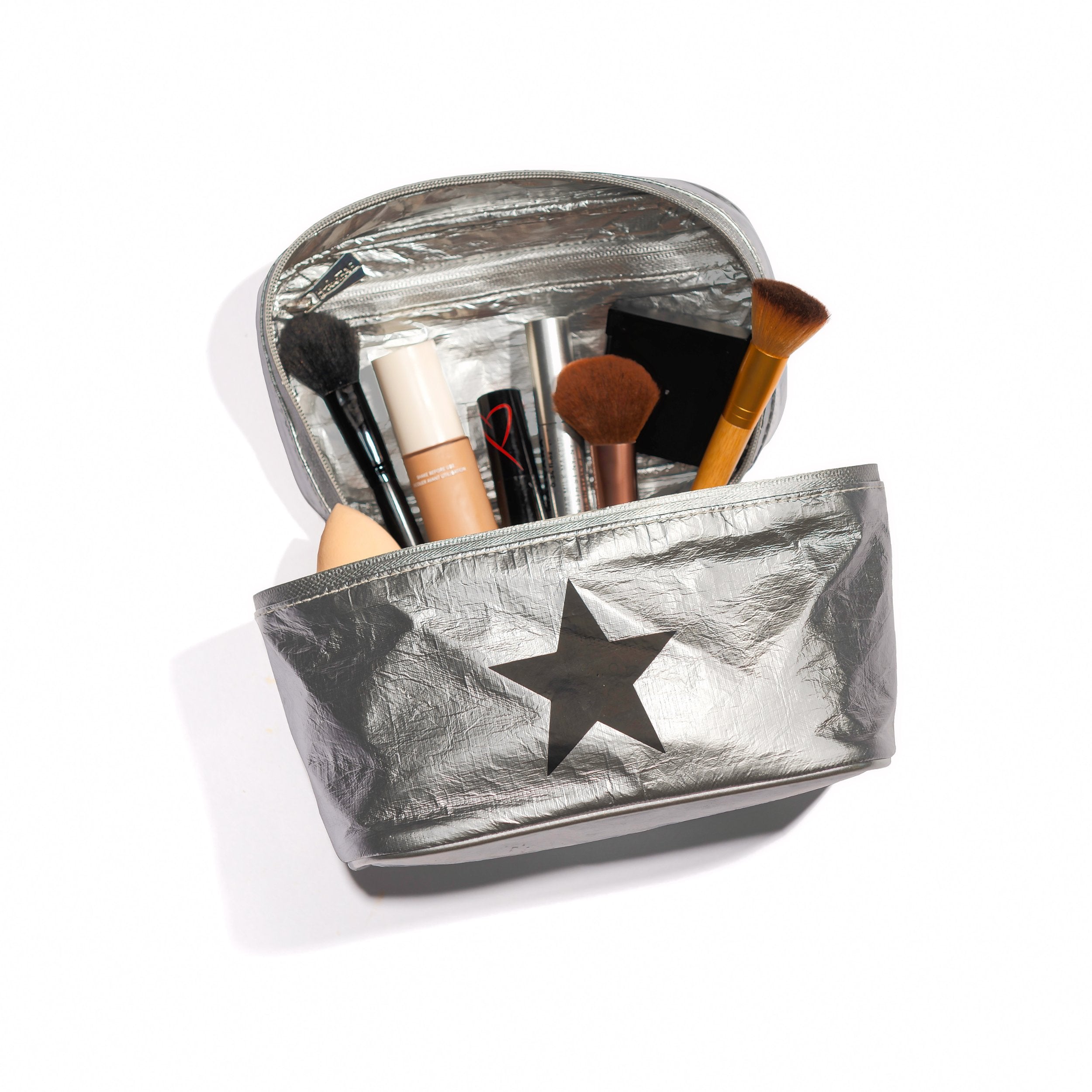 Silver cosmetic case with makeup and makeup brushes