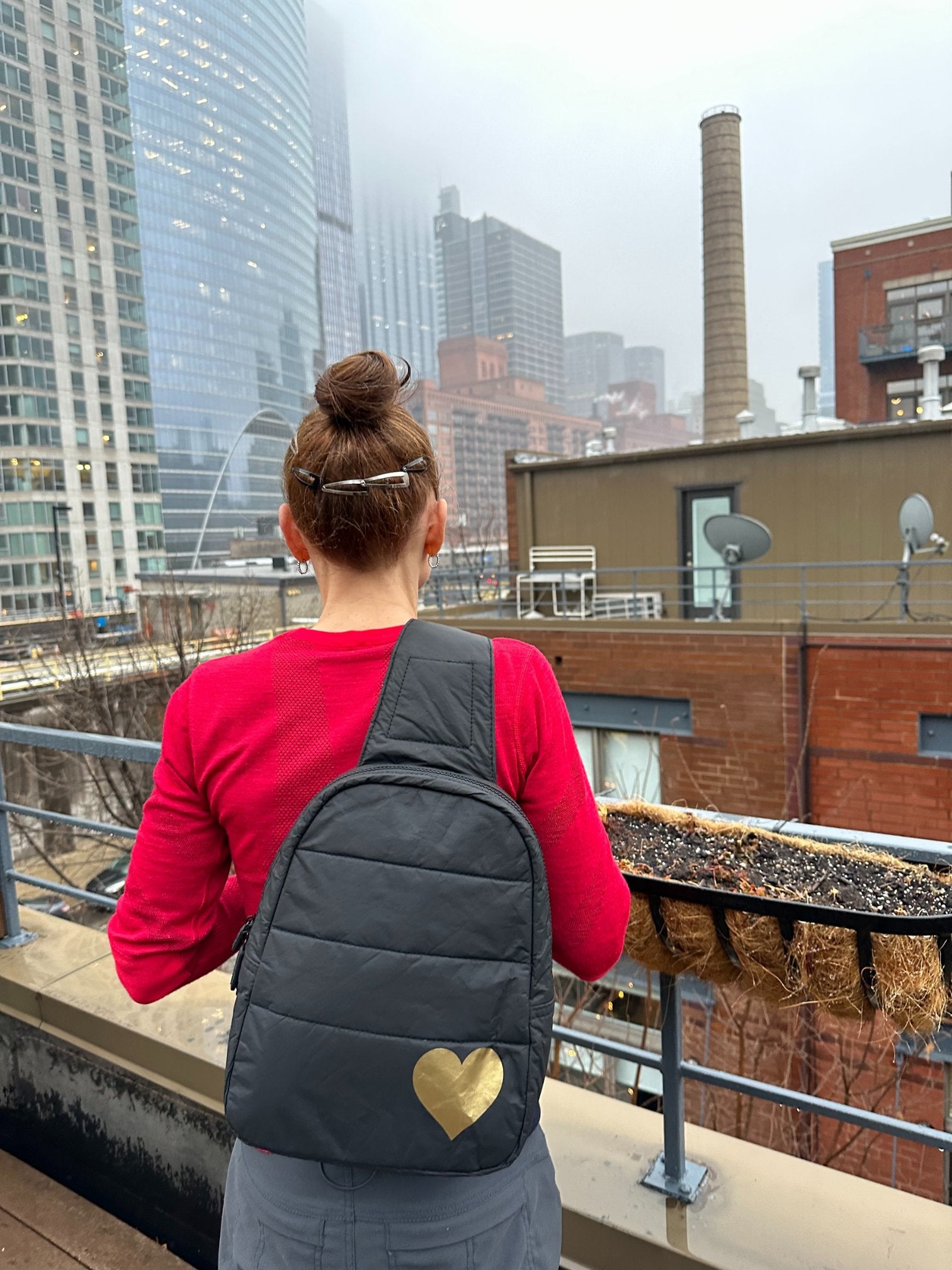 Woman wearing black crossbody backpack