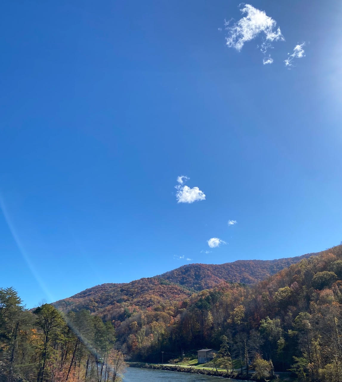 View of North Carolina mountain trees with green, yellow, and orange leaves