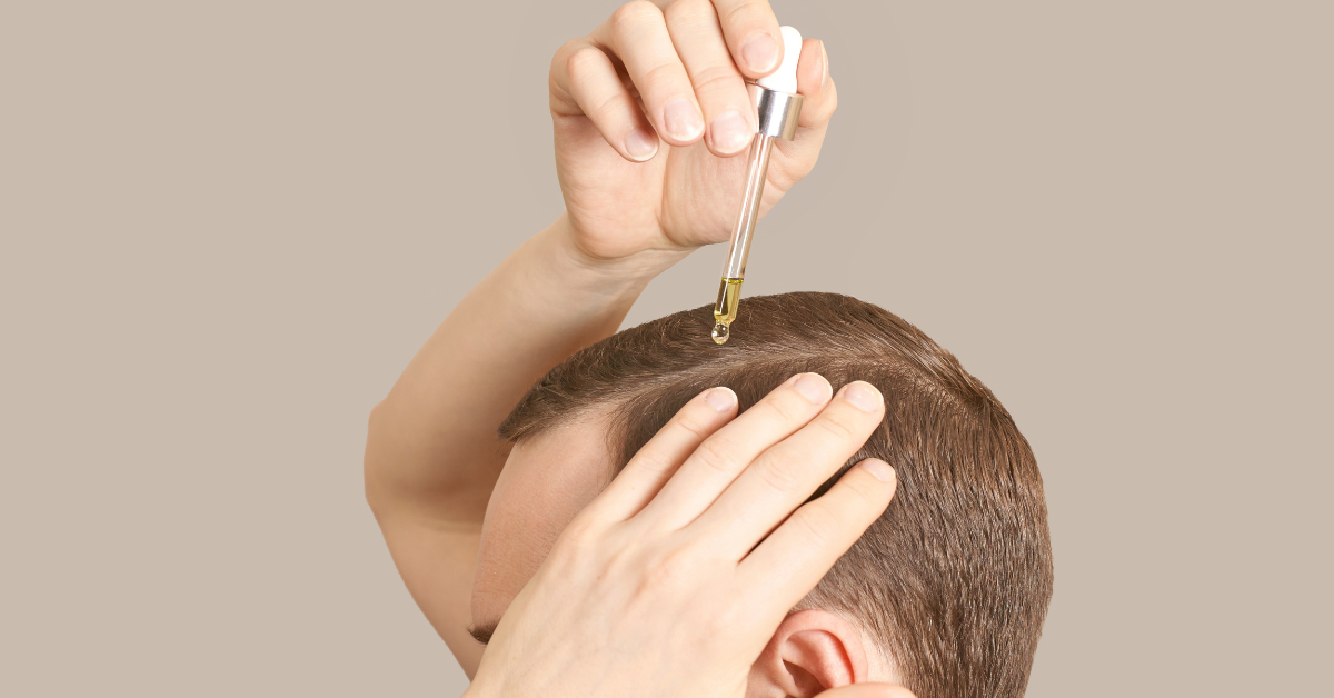 man applying serum as part of his hair growth routine