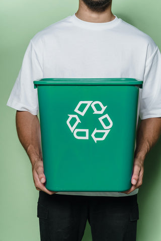 Man in White T-shirt holding a green box.