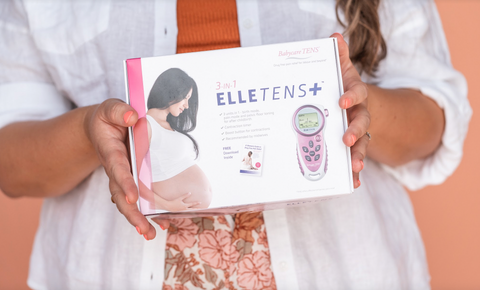 Bliss Birth founder holds the Elle Tens Plus obstetric TENS machine 