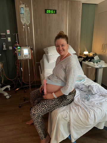 Felicity sits in hospital with fetal monitoring whilst in labour