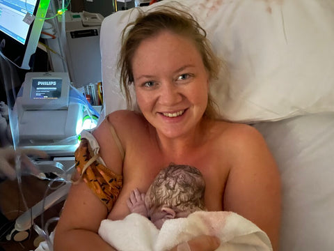 Felicity holds her newborn baby after giving birth in hospital after induction