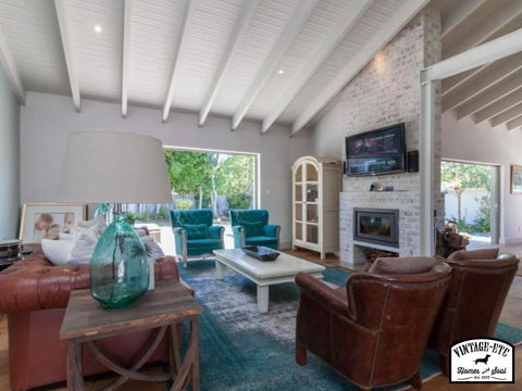 Living room with leather chairs and over dyed persian rugs