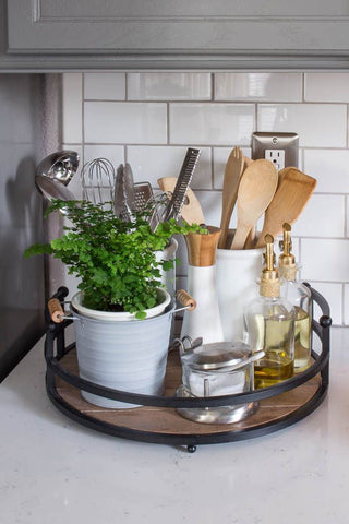 Wooden tray displaying salt container, a pot plant, a storage container/pot with utensils and wooden spoons, Olive Oil and vinegar and pepper. Interior design blog about our tips on bringing your kitchen to life without spending too much money. Written by vintage-etc in Cape Town. We make custom made & bespoke tables, benches, free-standing kitchen islands, desks, media units & wardrobes in our Cape Town & Johannesburg workshops – using Oak, Oregon, Ash, Beech, Birch Ply & Meranti. We also sell imported furniture, provide design consulting services & make soft furnishings e.g. sofas & upholstered chairs in linen, velvet & stain resistant fabric.