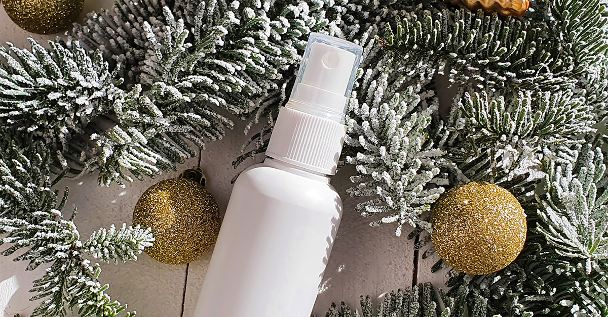 A spray bottle surrounded by snow covered tree branches