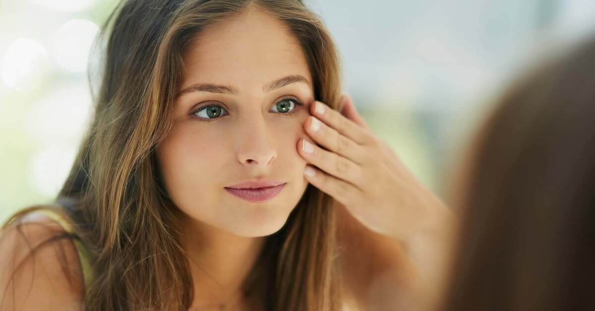 Woman looking at her reflection