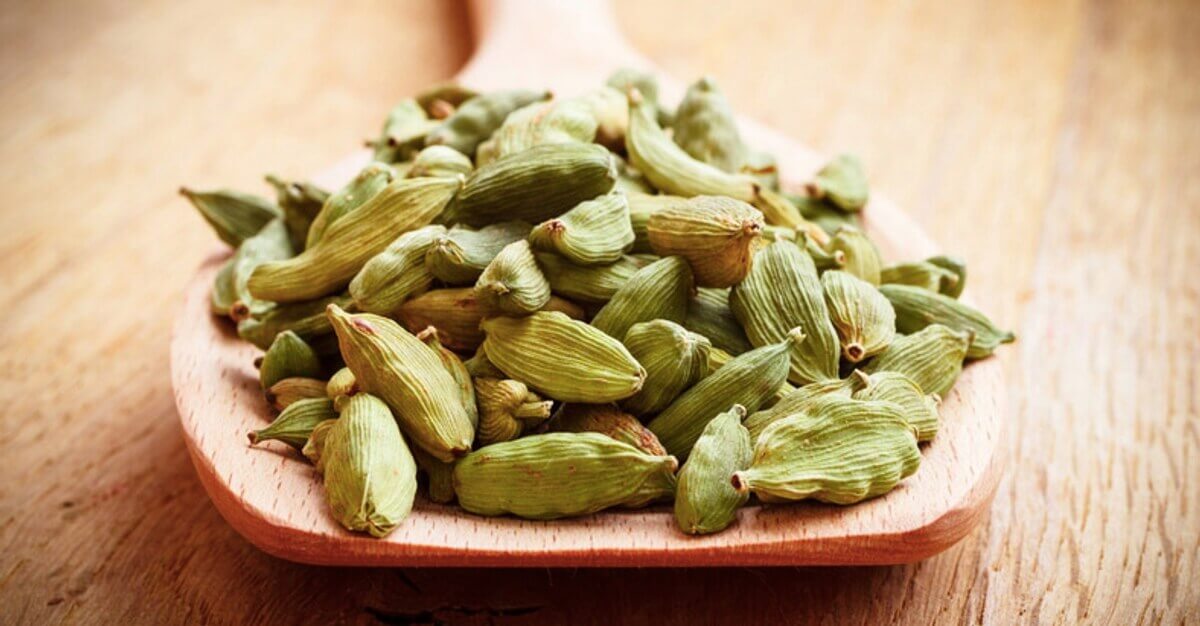 Cardamom seeds on a wooden spoon
